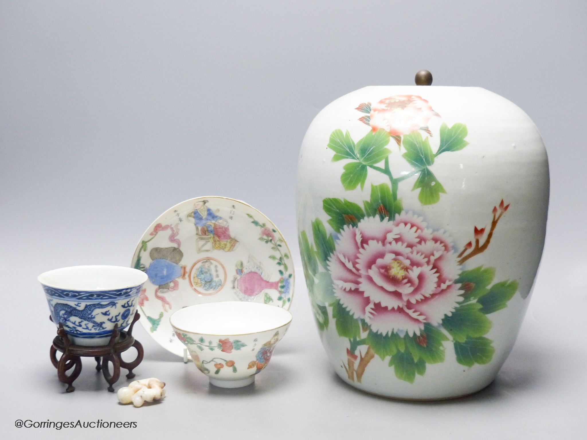 A 19th century famille rose bowl and stand, a blue and white cup, a famille rose jar and a stone carving of two monkeys